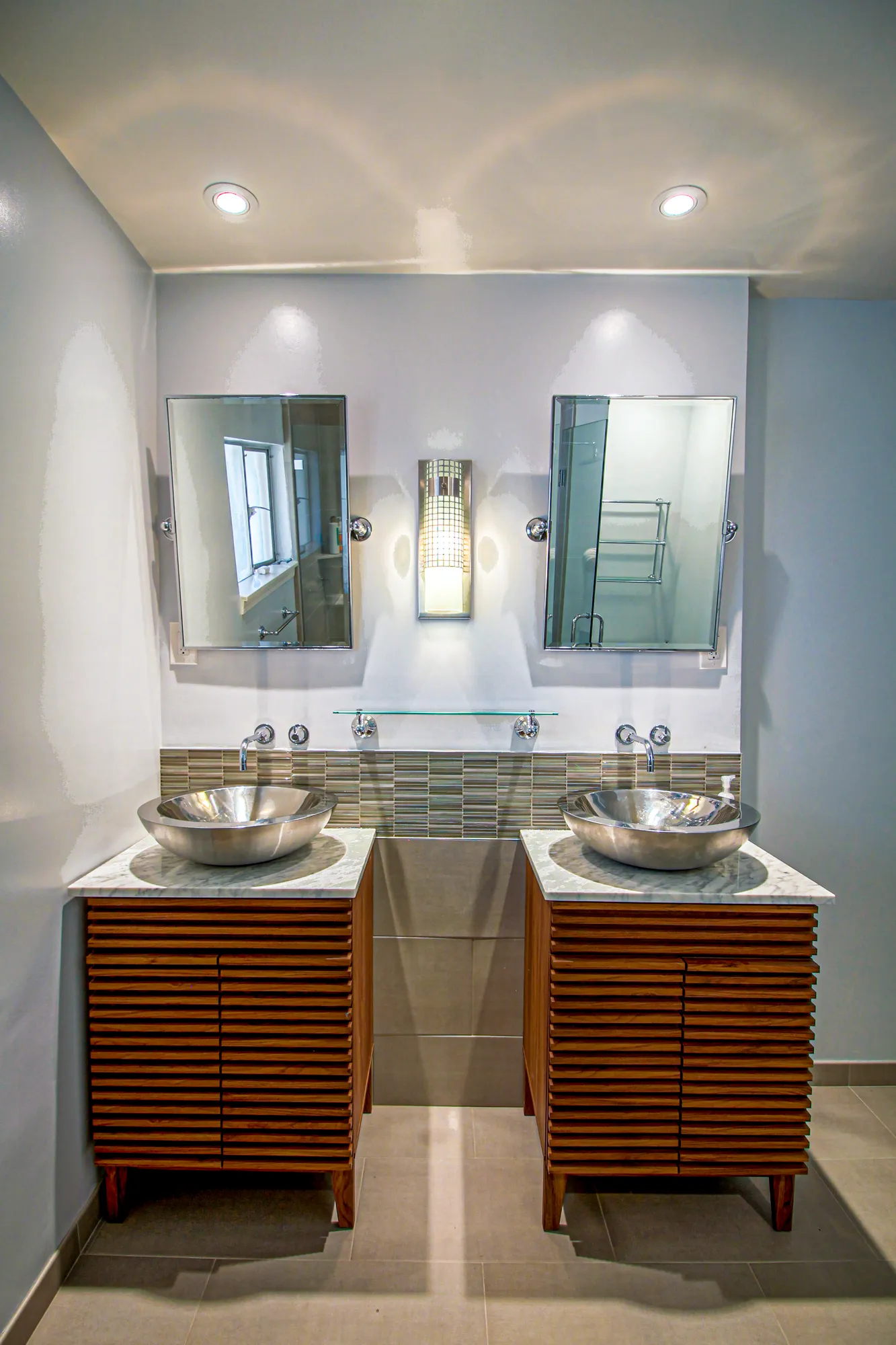 Primary bath with twin vessel sinks and walnut vanities